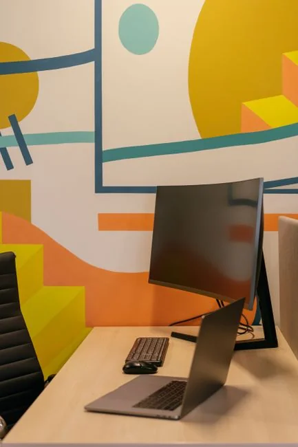 A creative workspace featuring UI design plans, pencils, a smartphone, and other office tools.